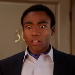 Troy from Community looking down in horror